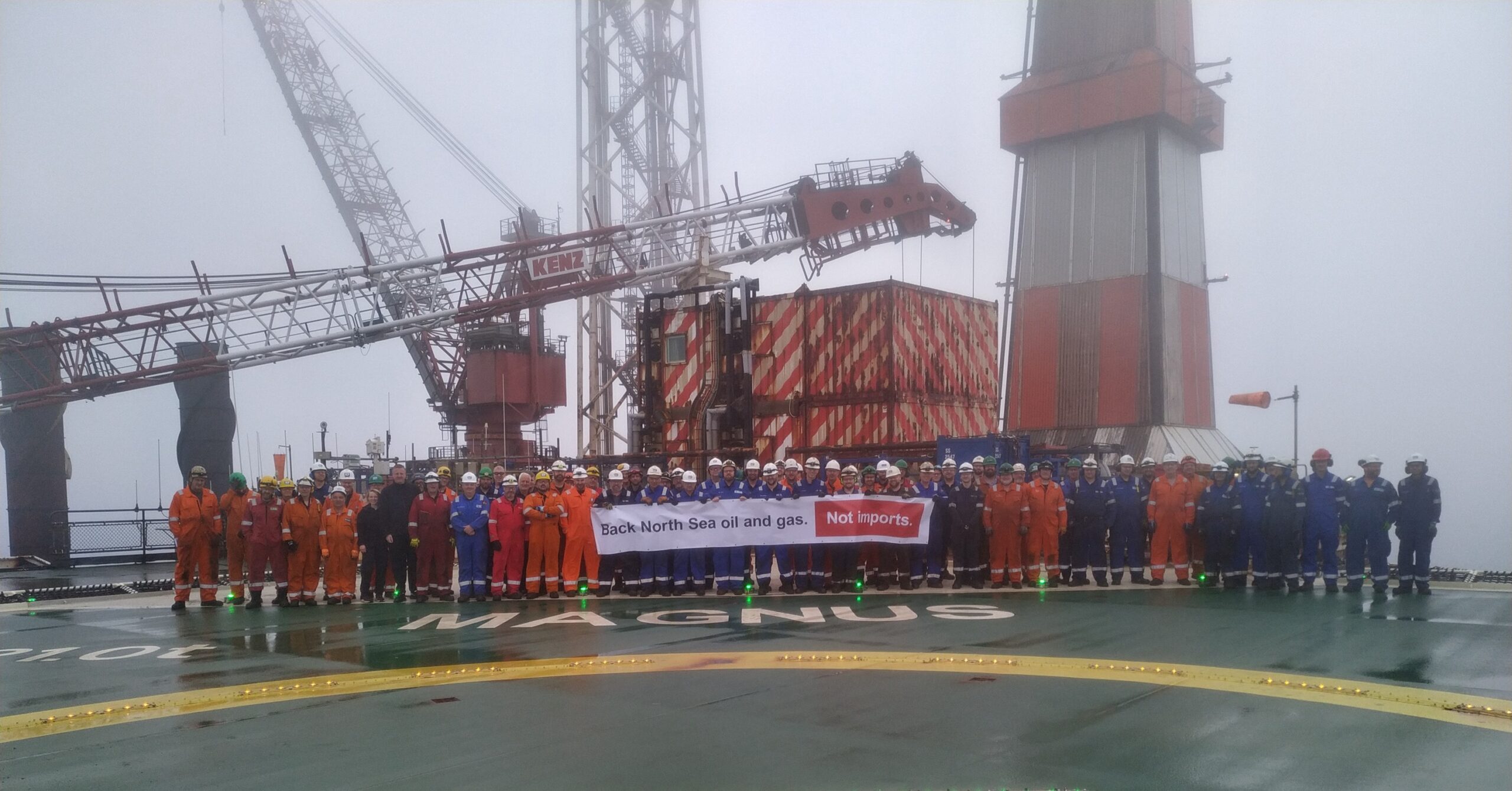 EnQuest offshore workers with the campaign banner.